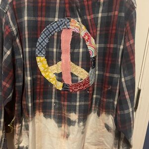 Hand bleached shirt with hand sewn appliqués